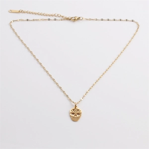 Gold hollow skull pendant necklace in stainless steel on a white background