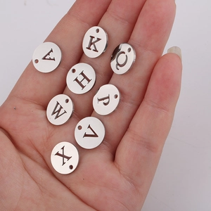 Pendentifs ronds ajourés de 12 mm en acier inoxydable poli pour la création de bijoux