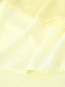 Detail of light yellow mesh fabric showing fine texture and professional overlock stitching