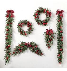 Detailed Christmas wreath set with flocked pine needles, red ornaments, and pinecones