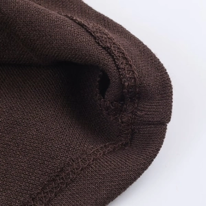 Macro shot of dark brown knit fabric texture with high-quality stitching detail