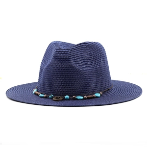 Detail of navy blue straw fedora with ethnic beads and brown woven decorative band
