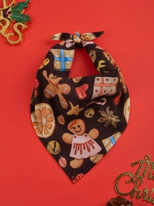 Detail of Christmas dog bandana with gingerbread man print on festive red background