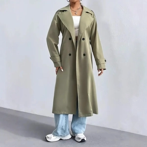 Detail of the olive green double-breasted trench coat with lapels and classic shoulder straps