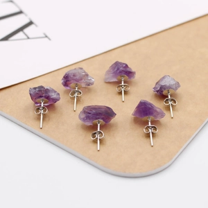 Detailed view of raw purple amethyst earrings with natural crystal texture and silver studs