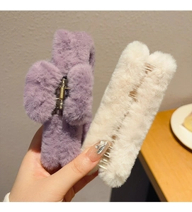 Detail of plush lavender and cream hair claw clips showing soft faux fur and spring
