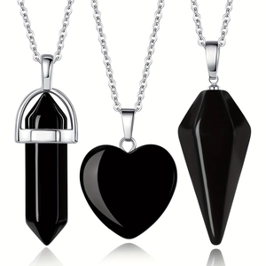 Detailed view of black natural stone pendants in hexagonal, heart and cone shapes