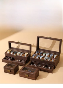 Detail view of walnut wood watch box with clear glass lid and gold metal clasp