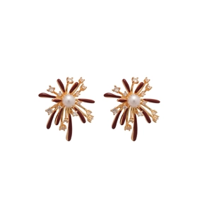 Elegant gold fireworks stud earrings with ruby red enamel and central white pearl