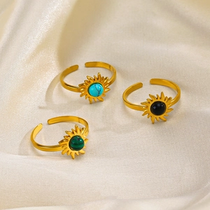 Adjustable sunburst rings with turquoise, obsidian, and malachite stones on champagne silk