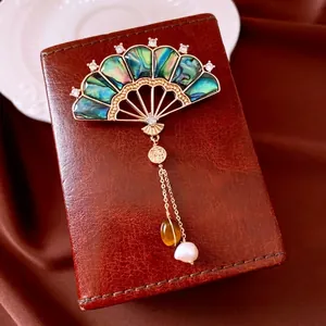 Gold vintage fan brooch with abalone shell, red crystal tassel and Fu character charm