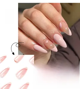 Detail of pink French press-on nails with almond shape and delicate heart accents