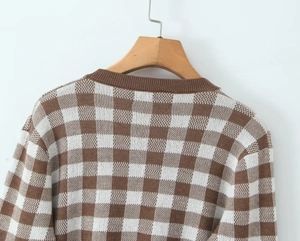 Detailed back view of brown and white checkered knit cardigan on a wooden hanger