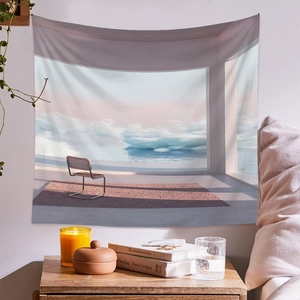Detail of artistic wall tapestry showing a surrealist dreamscape in a cozy room