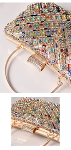 Macro detail of geometric colorful rhinestones and gold metal ring handle on evening clutch