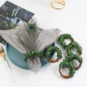Leaf woven napkin rings set with green plant design and peacock feather decoration