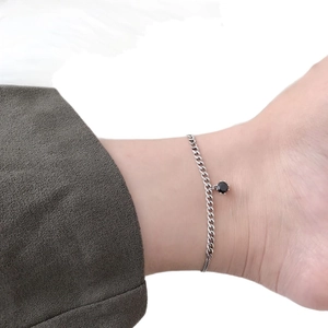 Minimalist S925 sterling silver anklet with black zircon stone on model ankle