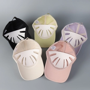 Close-up of five colorful cotton baseball caps with embroidered duck on soft top fabric