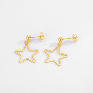 Close-up of golden hollow star stud earrings with polished finish and ball backings
