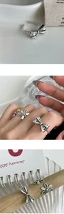 Macro detail of retro hollow flower and bow rings in oxidized silver finish