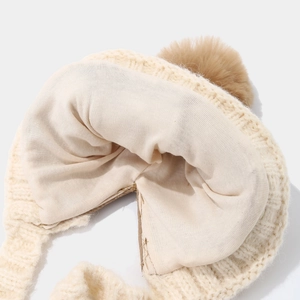 Knitted earflap hat with warm plush lining and brown faux fur pom-pom detail