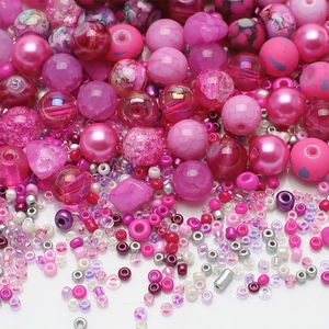 Macro detail of mixed pink and purple glass beads and faux pearls for DIY jewelry making