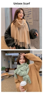 Detail of khaki and green scarves featuring soft fringe edges and fine knit texture