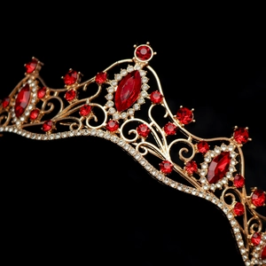 Macro view of gold bridal crown featuring marquise red gems and detailed crystal setting