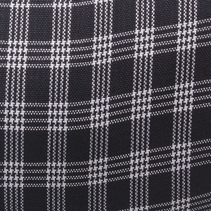 Close-up of the woven black and white plaid fabric texture of the octagonal newsboy cap