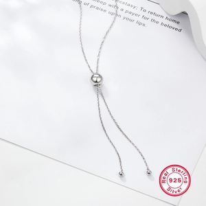Minimalist S925 sterling silver ball necklace with adjustable chain on white background