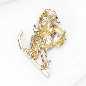 Macro detail of Christmas brooch gold back with silver rotary safety pin clasp