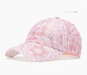 Macro detail of pink floral embroidery and sequins on breathable mesh baseball cap