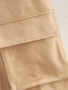 Macro detail of reinforced double stitching on khaki suede coat pockets and fabric texture