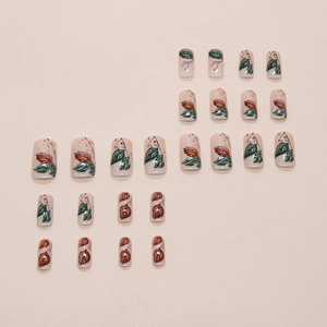 Press-on nails in square-oval shape with nature leaf patterns and golden glitter accents