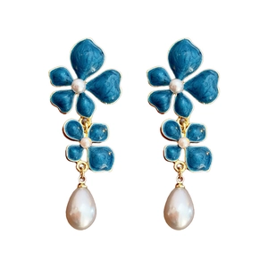 Vintage blue enamel flower earrings with teardrop pearls on a clean white background