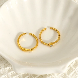 18K gold plated bead ring and zircon open ring set displayed in a white shell dish