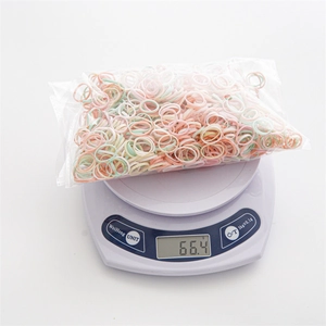 Macaron color elastic hair ties set in a polybag shown on weighing scale 66.4g