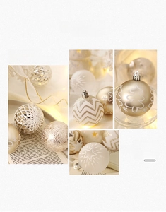 Detailed views of champagne gold and white Christmas balls with glittery stripe patterns