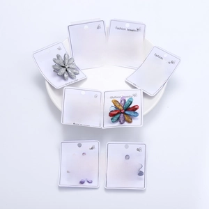Detail of faceted resin flower brooches with center rhinestone in various colors