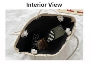 Top view of woven straw tote bag showing spacious black lining and magnetic closure