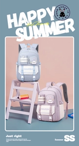 Detail of light blue and lavender student backpacks with cute cat patterns on a display