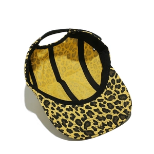Detail view of yellow leopard print 5-panel cap featuring adjustable leather strap buckle