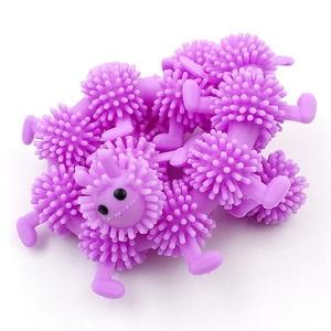 Purple spiky caterpillar sensory stress relief toys with black eyes on white background