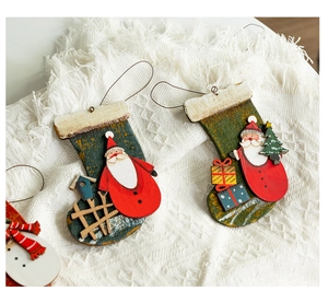 Detailed view of hand-painted wooden Christmas stocking ornament with red and green details