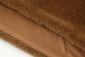 Close-up of caramel faux fur texture and smooth lining of the fashion winter shawl