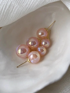 Macro shot of pink mermaid pearls with S925 silver studs on white matte tray