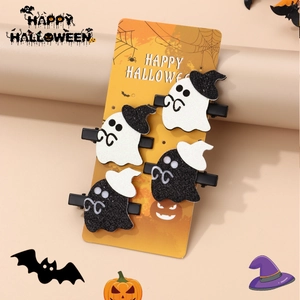 Detailed view of four ghost hair clips with glitter hats on a festive display card