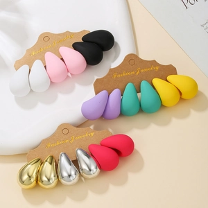 Close-up of assorted matte and metallic teardrop earrings on branded display cards