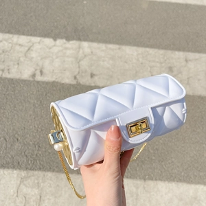 White quilted cylindrical jelly bag with gold chain and pearl accents for women