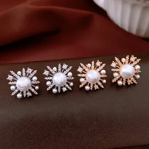 18k gold plated flower pearl stud earrings with sparkling crystals on premium leather background